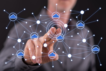 Man touching a cloud networking on a touch screen with his fingerの写真素材