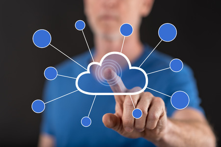 Man touching a cloud networking on a touch screen with his finger