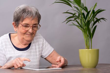 Elderly woman using a tablet