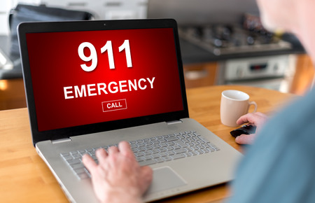Man using a laptop with emergency concept on the screen