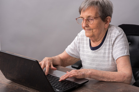 Elderly woman using a laptopの写真素材