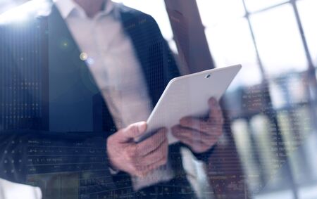 Businessman using tablet, light effect, double exposureの写真素材