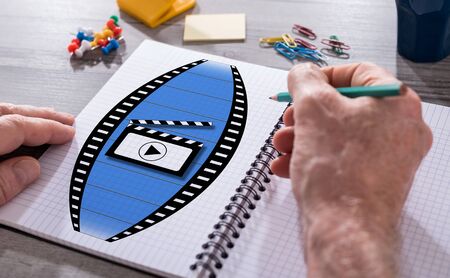 Hand drawing cinema concept on a notepadの写真素材