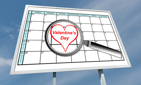 Valentines day on planner enlarged by a magnifying glassの写真素材