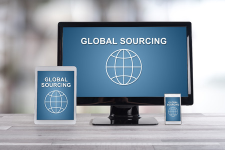 Global sourcing concept shown on different information technology devicesの写真素材