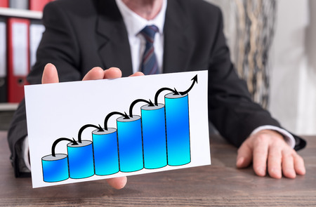 Businessman showing an index card with growth conceptの写真素材