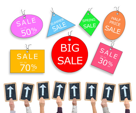 Hands holding writing slates with arrows pointing on sale conceptの写真素材