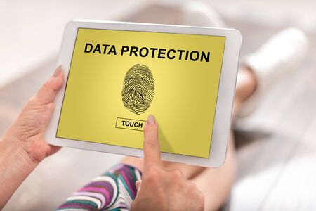 Woman using a tablet with data protection conceptの写真素材