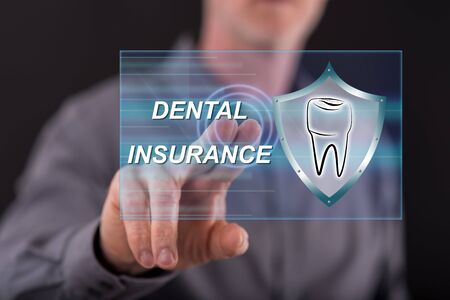 Man touching a dental insurance concept on a touch screen with his fingerの写真素材