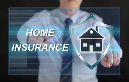Man touching a home insurance concept on a touch screen with his fingersの写真素材