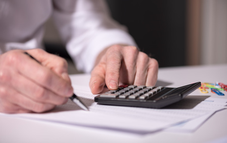 Male hand using calculator, accounting conceptの写真素材