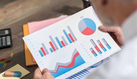 Businessman analyzing financial paperworkの写真素材