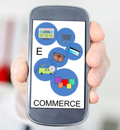 Hand holding a smartphone with e-commerce conceptの写真素材