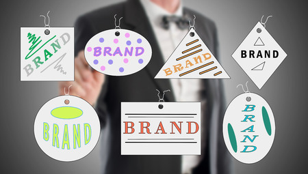 Brand concept drawn by a businessman in backgroundの写真素材