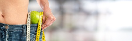 Woman having lost weight, concept of dietの写真素材