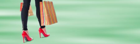 Woman walking with colorful shopping bagsの写真素材