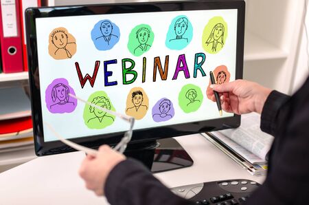 Businesswoman showing webinar concept on a computer screenの写真素材