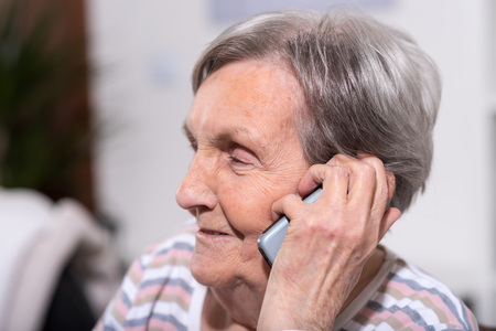 Senior woman using her phoneの写真素材