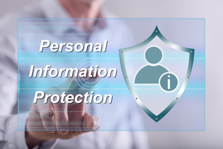 Man touching a personal information protection concept on a touch screen with his fingerの写真素材