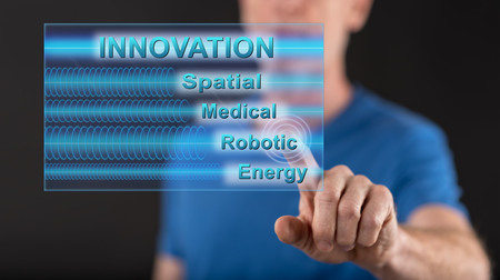 Man touching an innovation concept on a touch screen with his finger