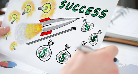Hands holding a paper showing a business success conceptの写真素材