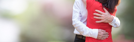 Couple hugging with love on blurred backgroundの写真素材