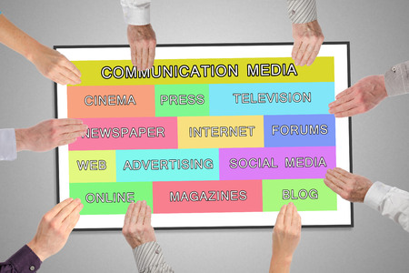 Communication media concept on a whiteboard held by handsの写真素材