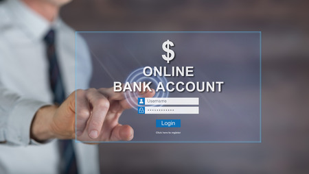Man touching an online bank account website on a touch screen with his fingerの写真素材