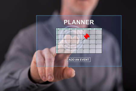 Man touching an event adding on planner concept on a touch screen with his fingerの写真素材