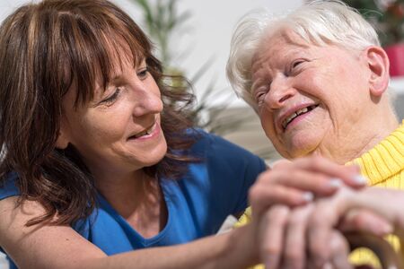 Portrait of happy grandmother with her daughter in visit