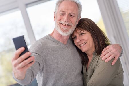 Happy mature couple taking a selfie