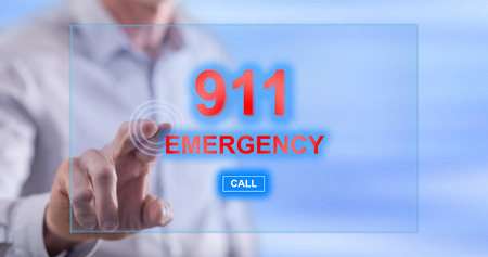 Man touching an emergency concept on a touch screen with his fingerの写真素材