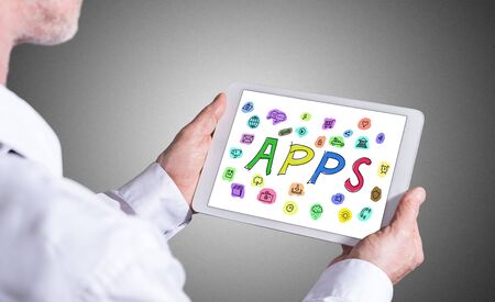 Man holding a tablet showing apps conceptの写真素材