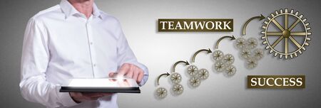 Man using a tablet with teamwork success conceptの写真素材