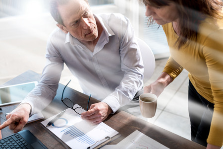 Coworkers having a business discussion in office, light rays effectの写真素材