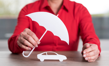 Insurer protecting a car, concept of insured carの写真素材