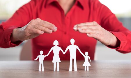 Insurer protecting family with his handsの写真素材