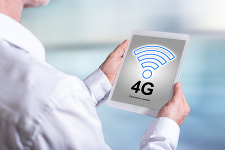 Tablet screen displaying a 4g network conceptの写真素材