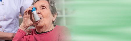 Senior woman using an asthma inhalerの写真素材