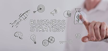Man touching a business strategy concept on a touch screen with his fingerの写真素材