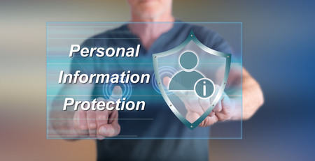 Man touching a personal information protection concept on a touch screen with his fingersの写真素材