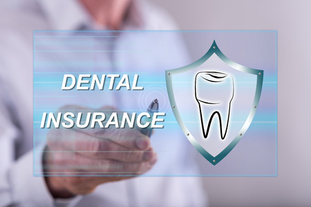 Man touching a dental insurance concept on a touch screen with a penの写真素材