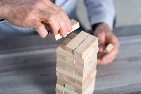 Business development concept by building a tower with domino blocks