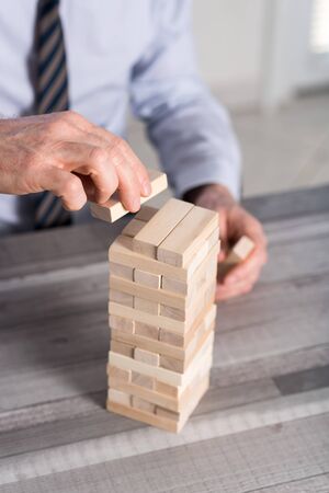 Business development concept by building a tower with domino blocksの写真素材