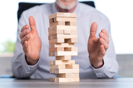 Concept of business risk with domino blocks