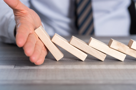 Business control concept by stopping domino effectの写真素材