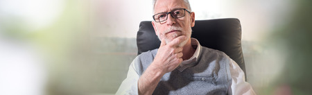 Portrait of senior businessman with hand on chin
