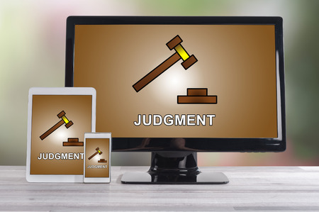 Judgment concept shown on different information technology devicesの写真素材