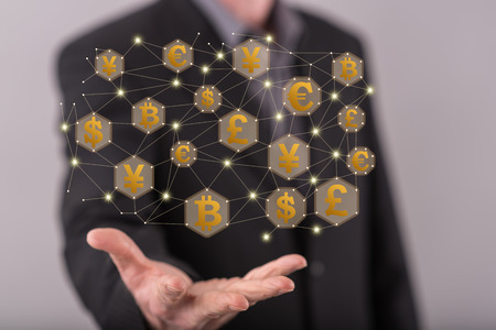 Currency exchange concept above the hand of a man in backgroundの写真素材