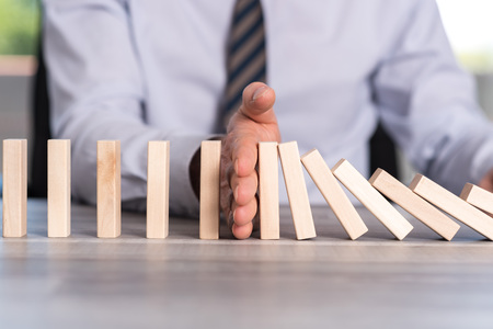 Business control concept by stopping domino effectの写真素材